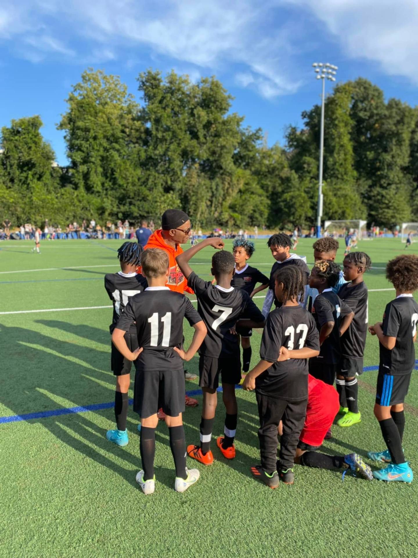 Coach Ed Armand giving team talk to youth players