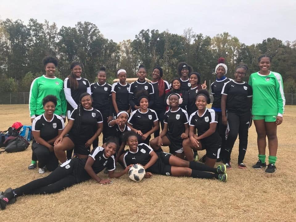 TAOSA FC girls team group photo on the pitch