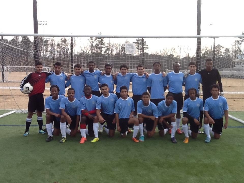 Full squad in light blue kits on the turf field