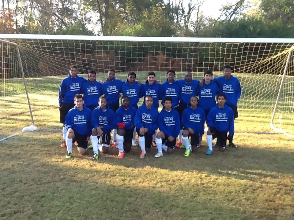 Team photo in blue hoodies under the goalposts